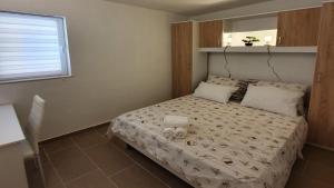 a small bedroom with a bed with towels on it at Kuća za odmor Zip in Murter