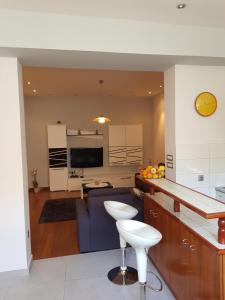 a kitchen and living room with a couch and a table at Apartment Centar Omis in Omiš