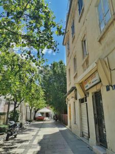 an empty street in a city with a building at Apartment Centar Omis in Omiš