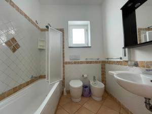 a bathroom with a tub and a sink and a toilet at Suite De Pasquale Lipari in Lipari