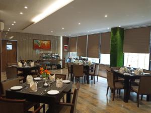 a dining room with tables and chairs in a restaurant at The Byke Signature Business - Pan India Pure Veg Hotel Chain in Bangalore