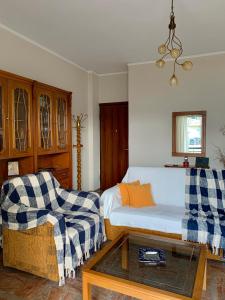 a bedroom with a bed and a couch and a coffee table at Hygge Retreat in Preveza