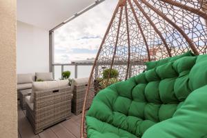 a room with a hammock on a balcony at Baltini Premium Apartament Kasprowicza in Kołobrzeg
