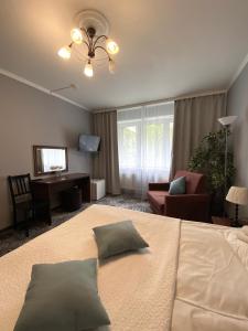 a bedroom with a bed and a living room at Vernisage on Ushinskogo in Saint Petersburg