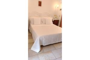 A bed or beds in a room at B&B DIMORA PALMIERI