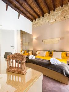 a bedroom with two beds and a table at B&B Carella in Palermo