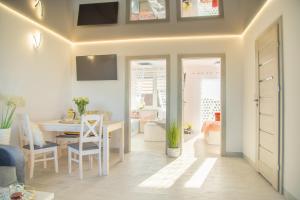 a living room with a table and a dining room at Apartamenty Scarlet in Darłowo