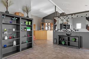 a living room with gray shelves with plants on them at Hotel Kvika in Ölfus