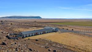 a building in the middle of a dirt field at Hotel Kvika in Ölfus