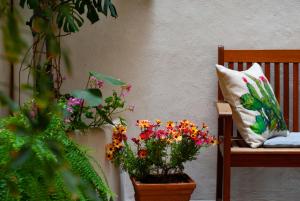 a bench with a pillow and some flowers on it at Affittacamere B&B Carella in Palermo