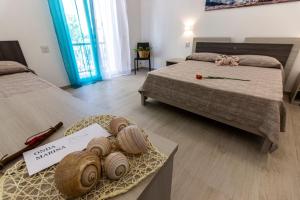 A bed or beds in a room at Incanto di luna B&b Family Rooms