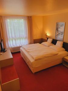 Posteľ alebo postele v izbe v ubytovaní Hotel Baden-Baden