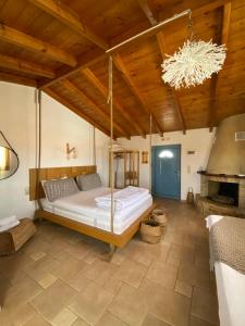 a bedroom with a bed and a chandelier at Kalomoira's Apartments in Elafonisos