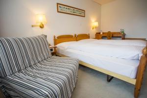 Postel nebo postele na pokoji v ubytování Motel de la Gruyère Restoroute
