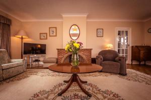 a living room with a vase of flowers on a table at Green Pastures cottage in South Downs in Eastdean