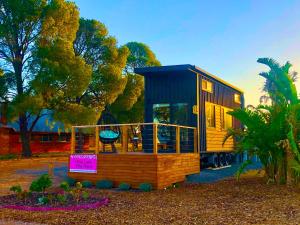 a tiny house on display in a yard at The Pink Lake Tiny House - 'Sakura' in Lochiel