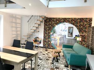 a living room with a blue couch and a table at Maison spacieuse à Saint-Hernin, idéale pour groupes in Saint Hernin