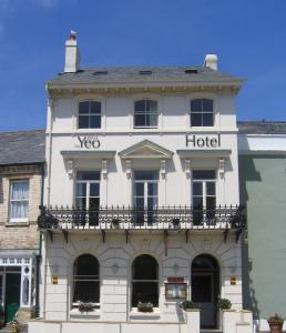 a white hotel with a balcony on the front of it at Yeo Dale Hotel in Barnstaple