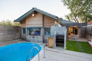 a backyard with a swimming pool and a house at Spa Villa Skaloma in Nafpaktos