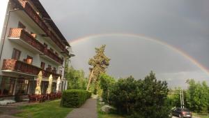 a rainbow in the sky above a building at Penzión ERIKA in Vysoké Tatry