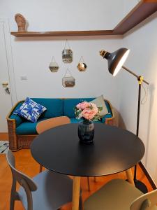 a living room with a table with a lamp and a couch at Annina Home in Paestum