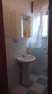 a bathroom with a white sink and a shower at casa dei limoni in Peschici +34 photos