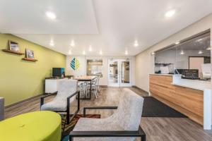 a waiting room with chairs and a table at WoodSpring Suites Linden in Linden