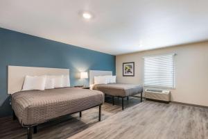 a hotel room with two beds and a window at WoodSpring Suites Linden in Linden
