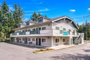 a large white building with a porch at Quality Inn & Suites Bainbridge Island in Winslow