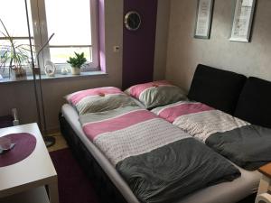 a bed with two pillows on it in a room at Sonnengruß in Cochem