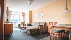 a living room with a couch and a table at Landhaus Ehrengrund in Gersfeld