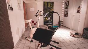 a room with a gym with exercise equipment in it at Landhaus Ehrengrund in Gersfeld