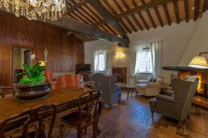 a large living room with a table and chairs at Antica Magnolia, historical Retreat in Versilia in Camaiore