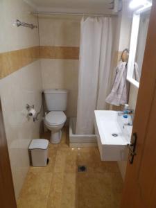 a bathroom with a toilet and a sink at Nestor Sea Studio in Preveza +18 photos