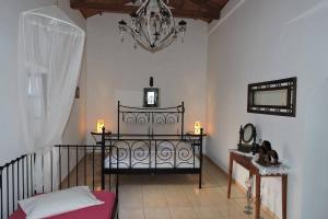 a room with a bed and a chandelier at The Arch in Logothetiánika