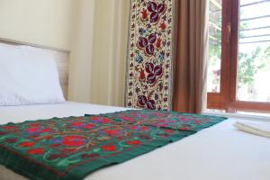 A bed or beds in a room at Guest House Ruslan Nurata & Tours
