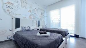 a bedroom with two beds and a large wall at INFINITY VIEW Arenales in Arenales del Sol +125 photos