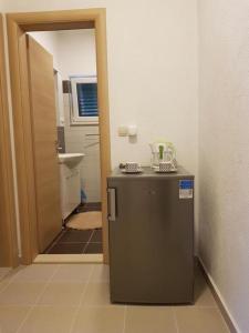 a small refrigerator in a bathroom with a sink at "Laurier" rooms & apartments in Celina