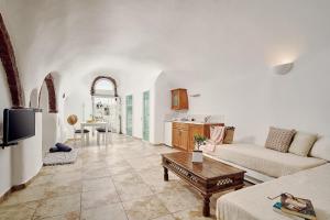 a living room with a couch and a table at Santorini Mansion at Imerovigli in Imerovigli