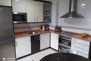 a kitchen with white cabinets and a stainless steel refrigerator at Vivienda Briviesca La Vega 2 in Briviesca