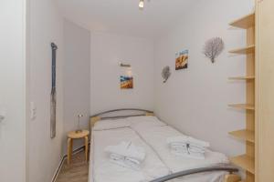 キュールングスボルンにあるStrandstrasse-16-Wohnung-23-App-Molli-377の小さなお部屋で、ベッド1台、野球バットが備わります。