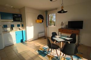 a kitchen with a table and chairs in a room at appartement studio in Prayssac