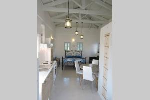 a kitchen with a table and a bed in a room at Elena Studio in Logothetiánika +19 photos