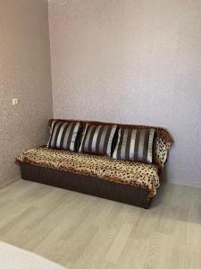 a couch sitting in a corner of a room at Сдаётся 1-комнатная квартира в Гаграх in Gagra