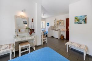 a living room with a dressing table and a mirror at Margarita Studios in Parikia