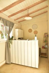 a kitchen with a white counter in a room at Idomeneas Apartments in Sougia