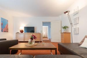 a living room with a couch and a coffee table at Seehotel Lindenhof in Lychen