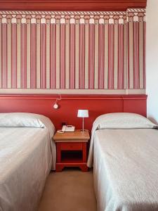 Postel nebo postele na pokoji v ubytování MH HOTEL VARAZZE