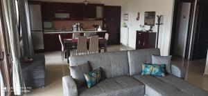 a living room with a couch and a kitchen at Fotini's Apartment in Nea Peramos