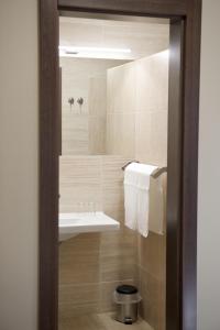 a bathroom with a sink and a mirror at Napkelte Panzió in Napkor